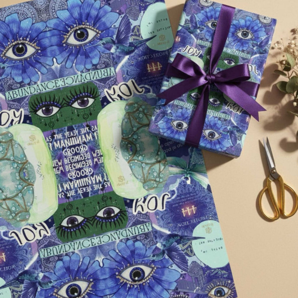 Joy abundance manifestation journal wrapped in matching illustrated paper with purple ribbon, styled as a gift