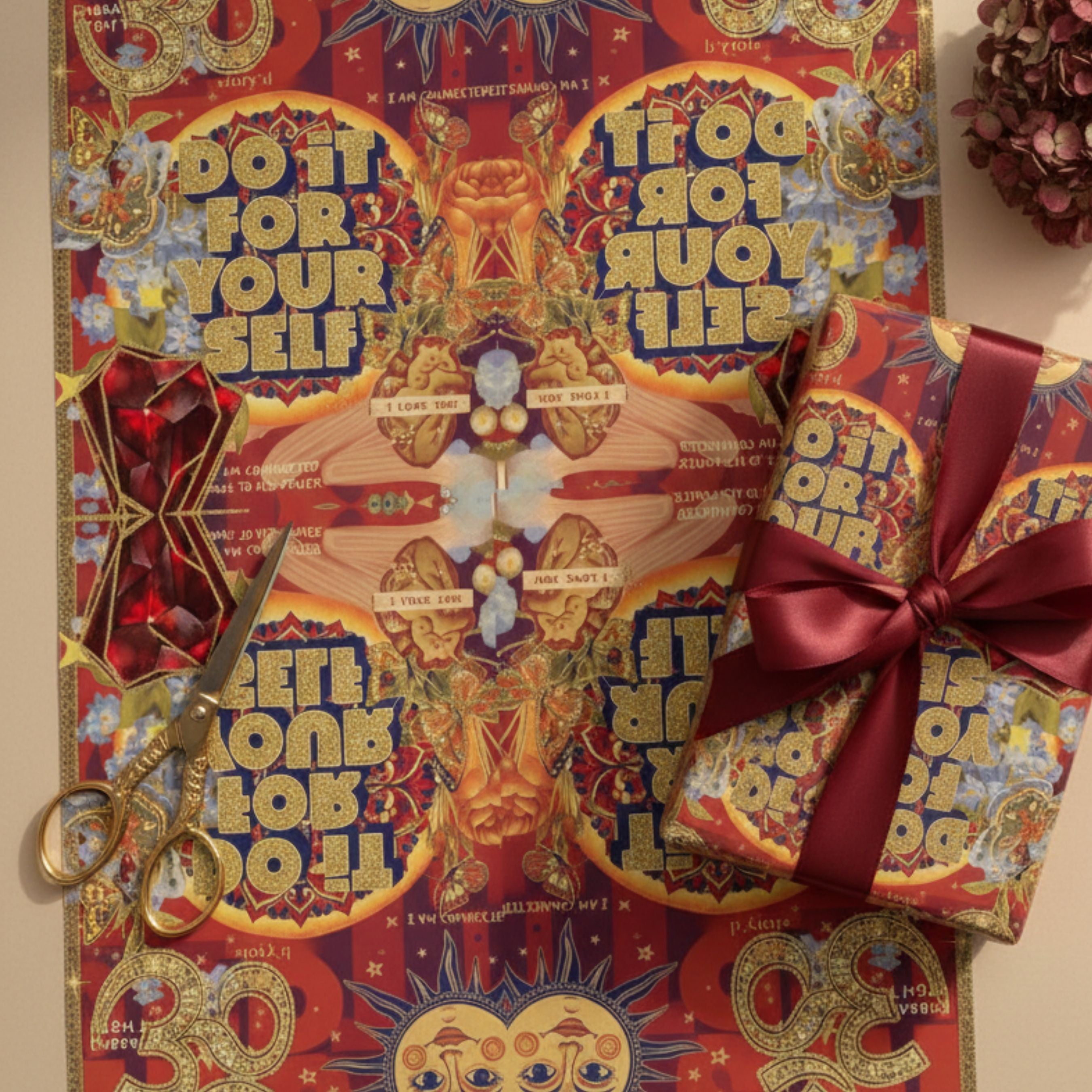 Decorative gift box with colorful design and text, accompanied by a pair of scissors.