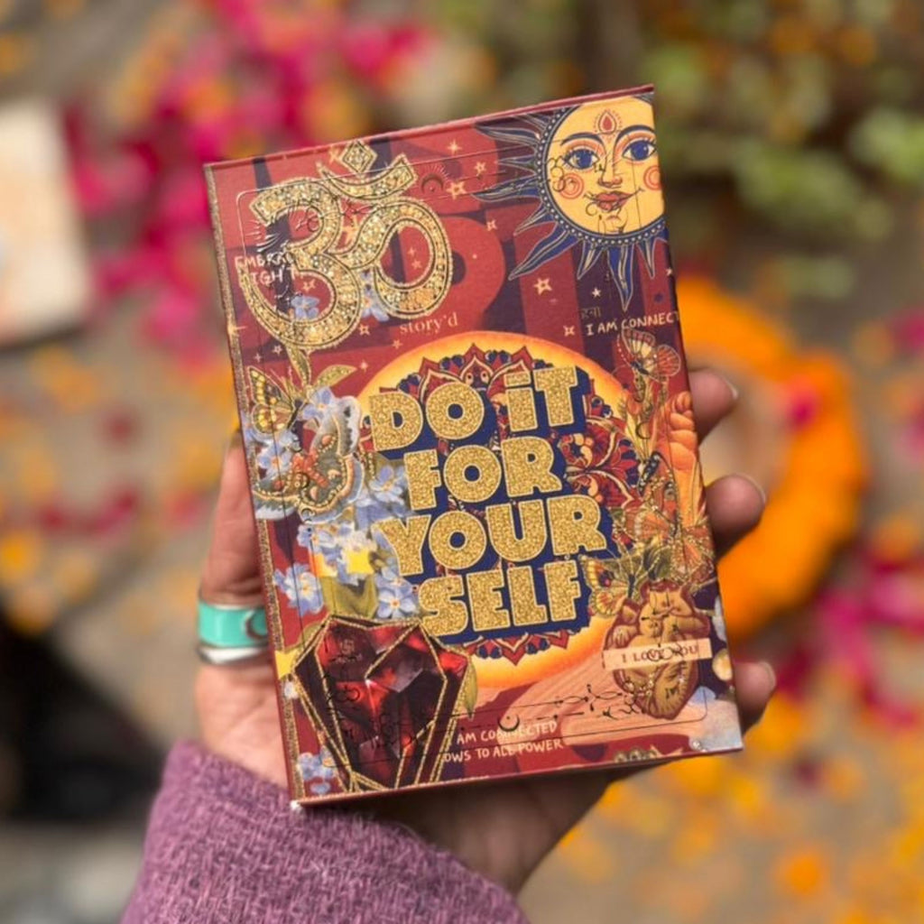 Decorative book titled 'Do It For Yourself' held by a person with a colorful blurred background.