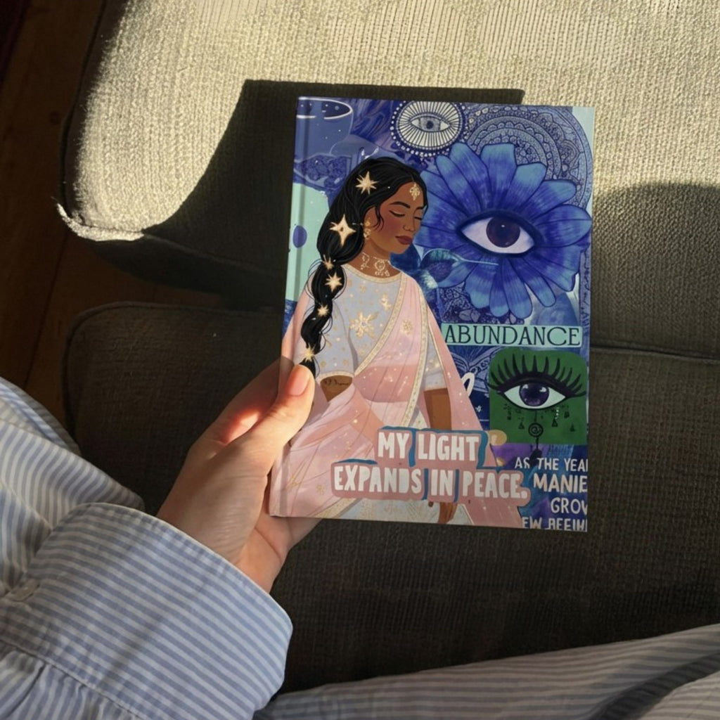 Joy abundance manifestation journal with illustrated cover, gift wrapped in matching paper with purple ribbon, including bookmark, designed for journaling, manifestation, gratitude, reflection and intentional living