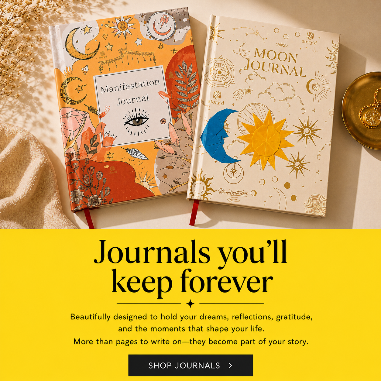 Two decorative journals are shown on a styled surface: a Manifestation Journal with an orange cover and a Moon Journal with a cream cover. Below the products is a yellow promotional banner with text reading 'Journals you'll keep forever' and a 'SHOP JOURNALS' button.